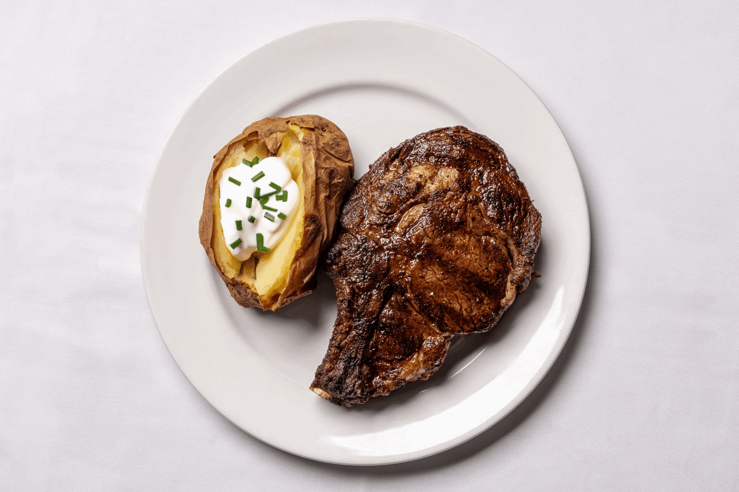 Barberian's rib steak and baked potato from barberians.com