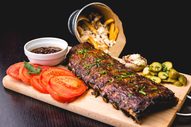 Premium dry-aged steak on a cutting board with Italian accompaniments