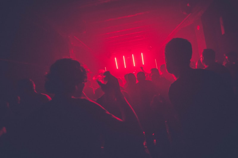 Modern nightclub with neon lights and energetic crowd