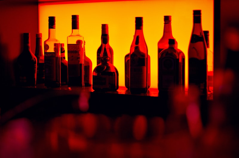 Intimate dimly lit cocktail bar with candles and moody atmosphere