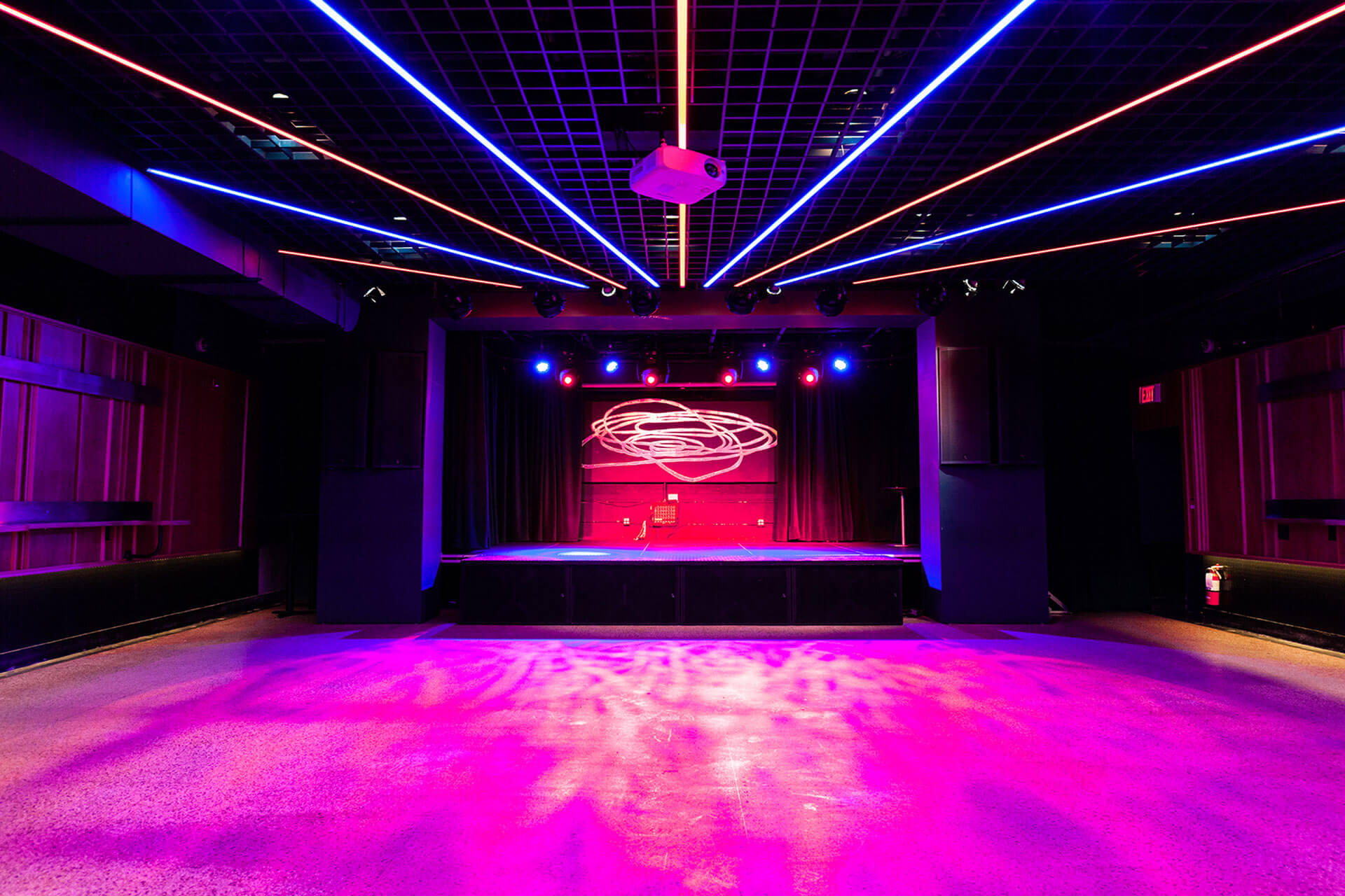 The Drake Underground’s neon-lit basement stage, from the official Drake site