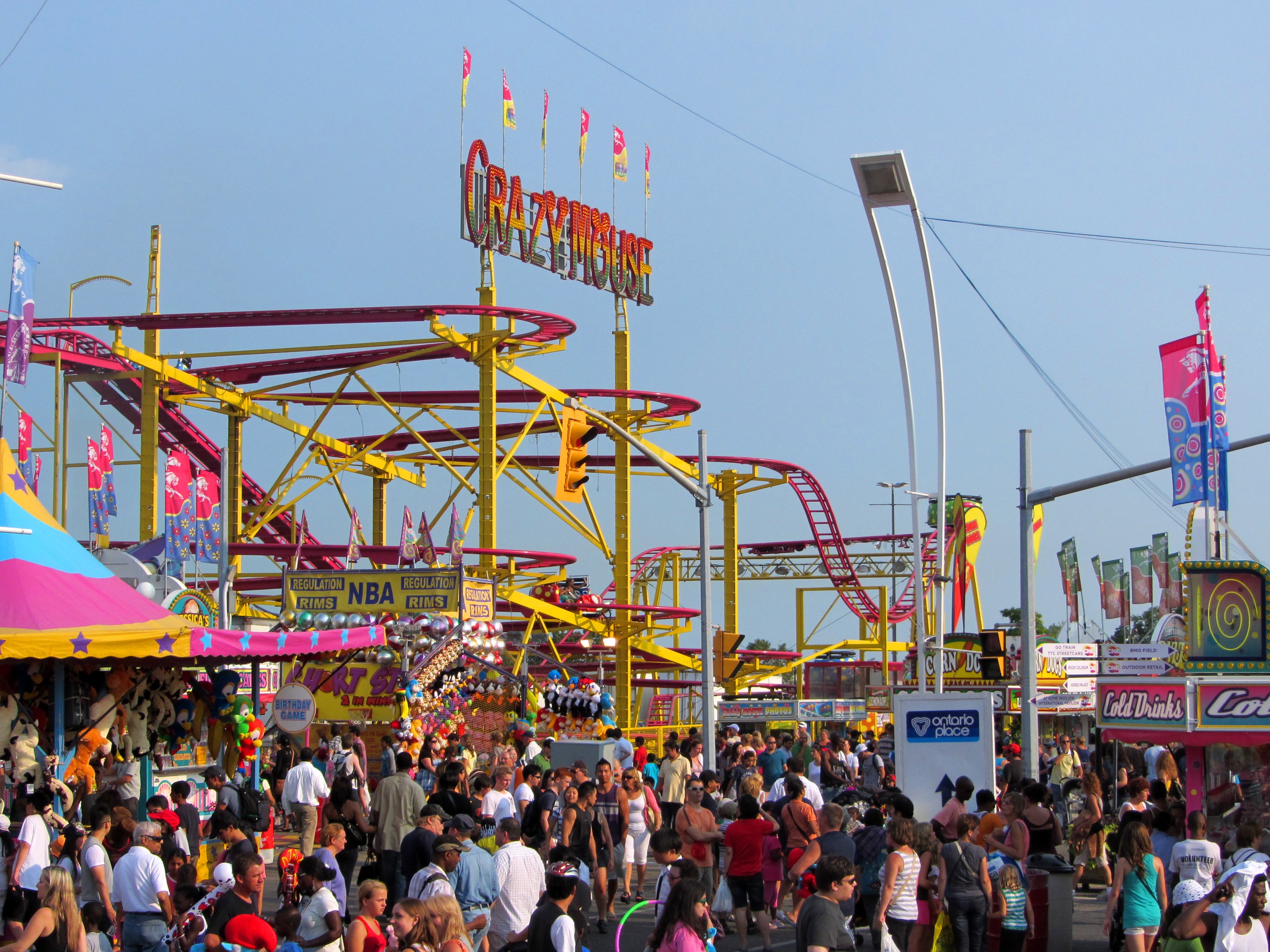 The CNE midway at Exhibition Place, with the Crazy Mouse and summer crowds