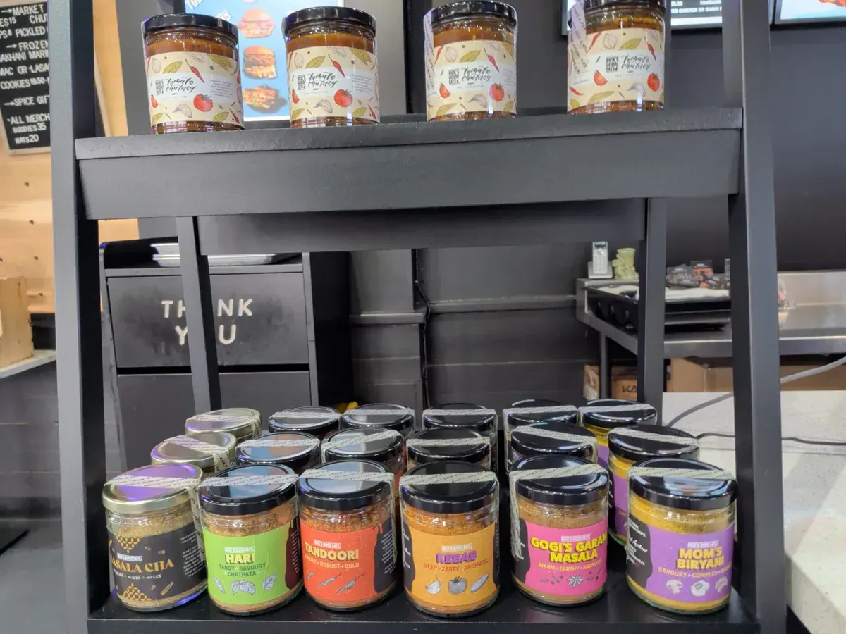 Shelves stocked with house-made spices and chutneys
