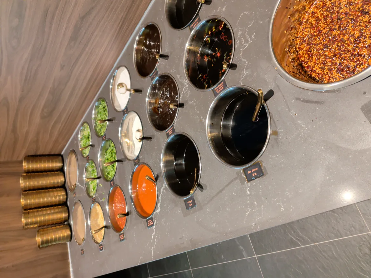 The sauce bar with various bowls of condiments