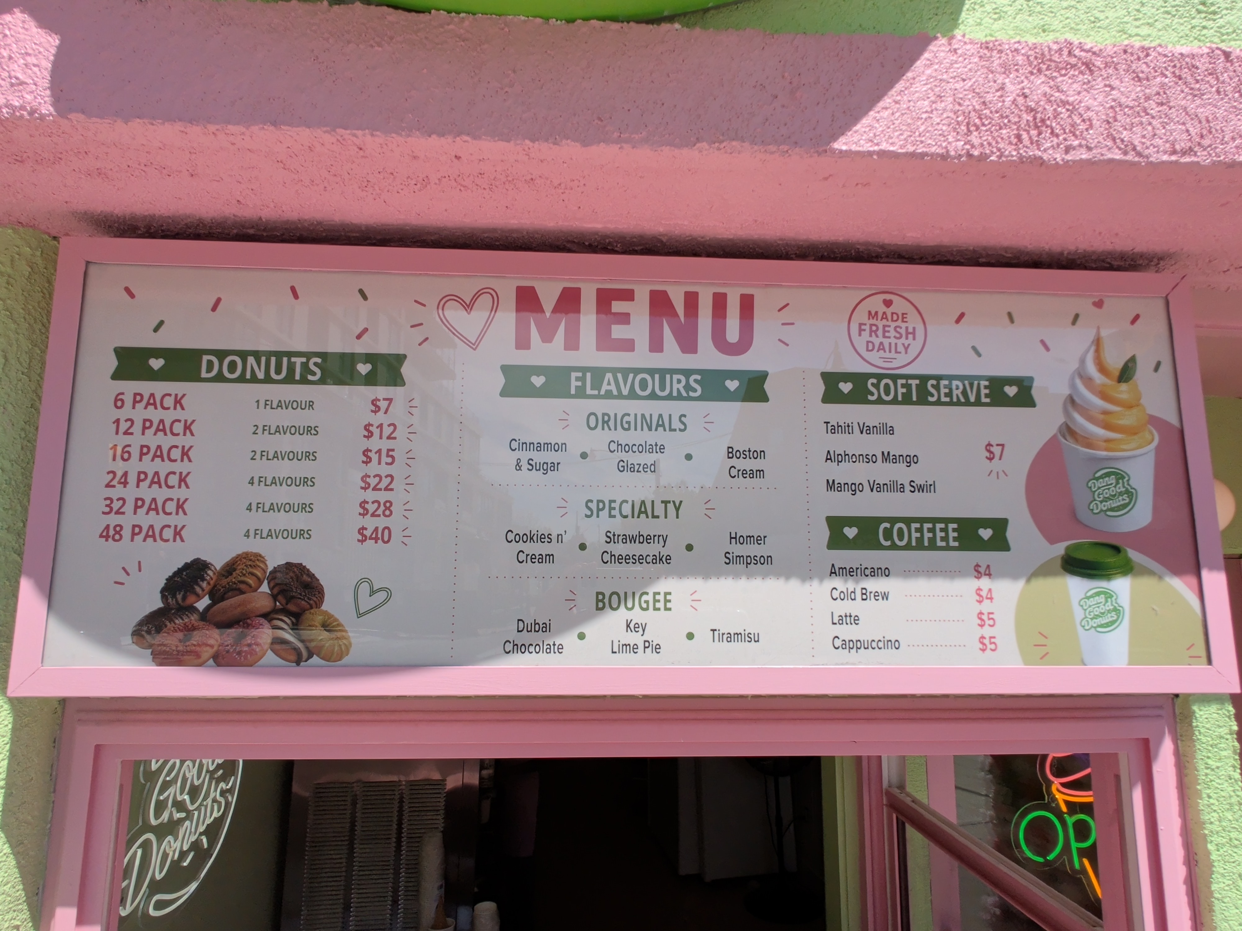 The menu board at Dang Good Donuts displaying various donut packs, flavours, and soft serve options