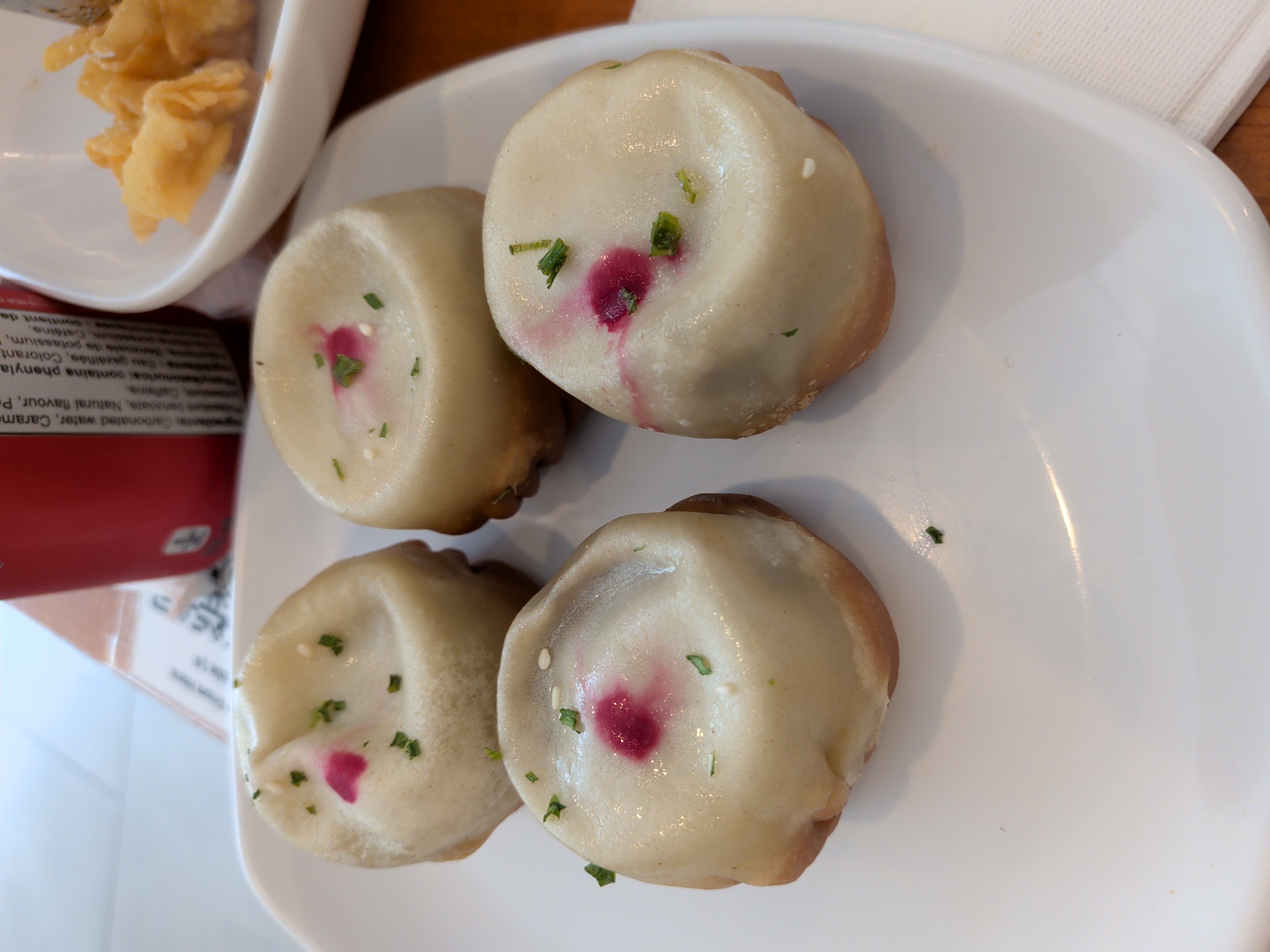Truffle fried bao with a pink dot on each bun