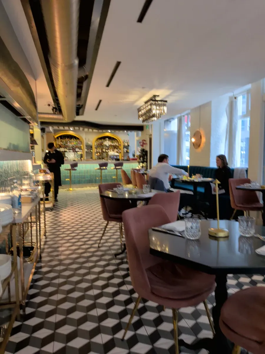 The interior of Bar Goa with velvet chairs and geometric tiles